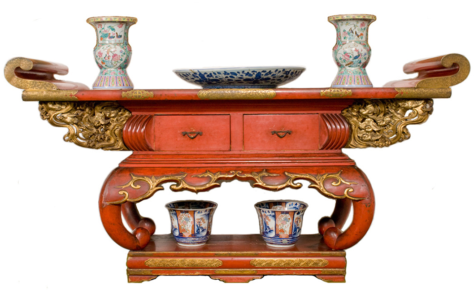 A red lacquered Buddhist altar table from Japan. A red lacquered Buddhist altar table from Japan.