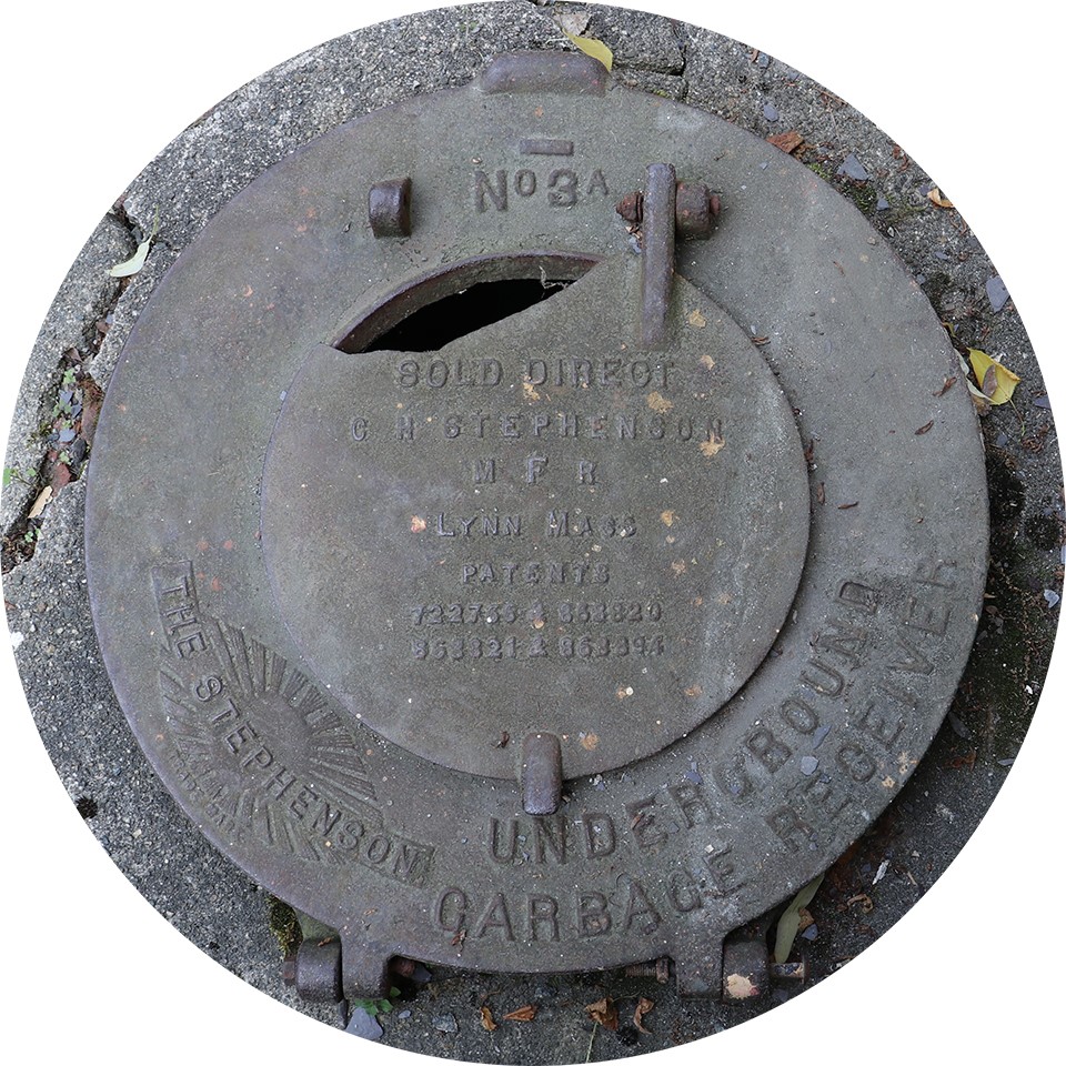 A circular metal hinged lid with 