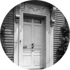 round black and white photo showing the front door of a house