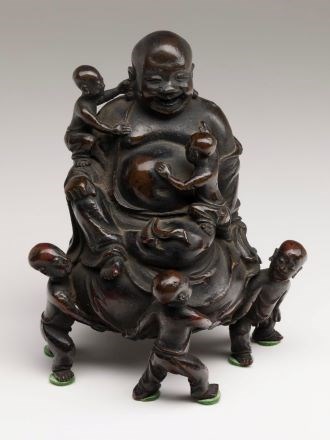 Bronze figurine of laughing Buddha surrounded by seven boys