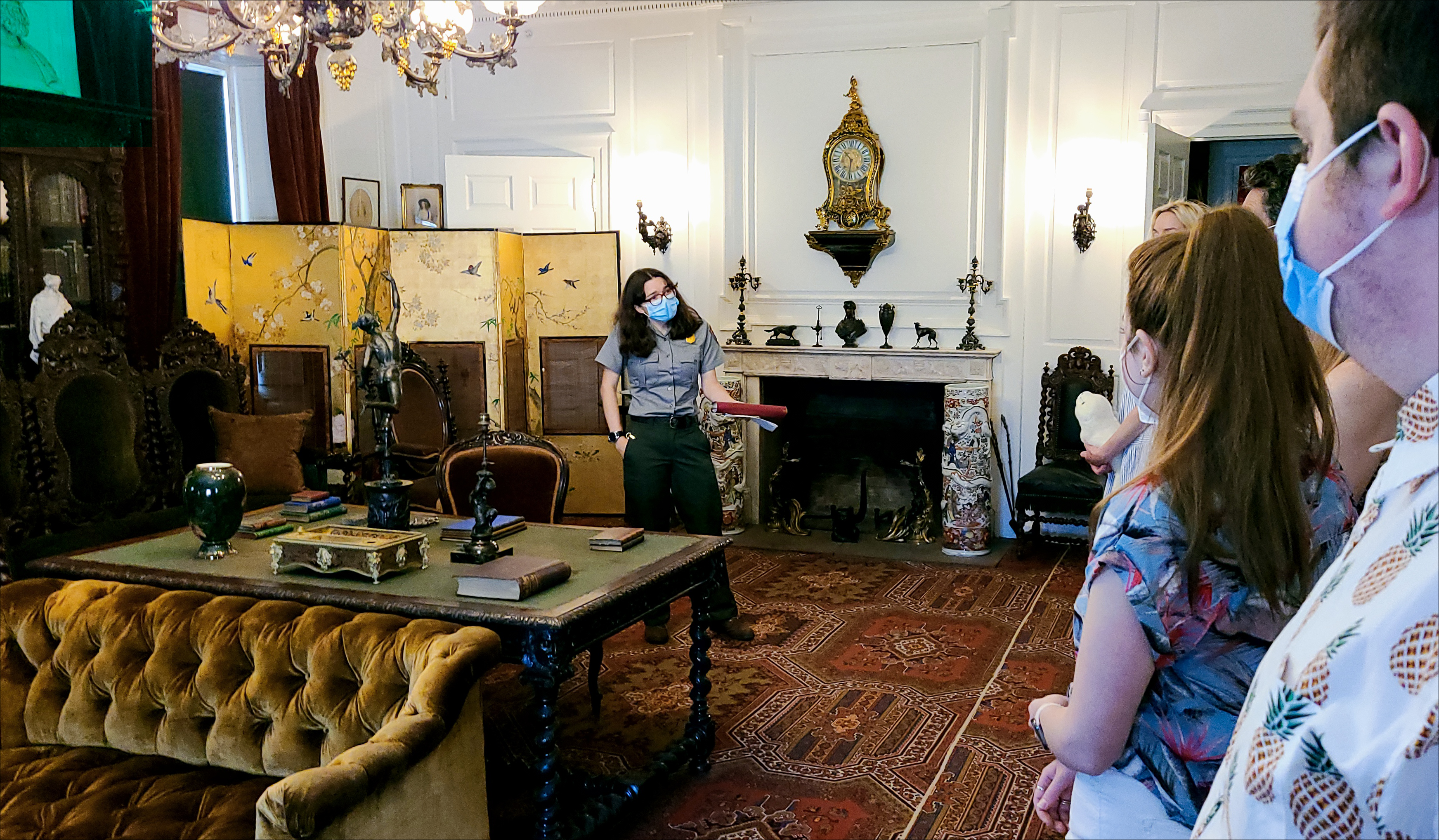 Ranger talking with visitors in the Longfellow House library