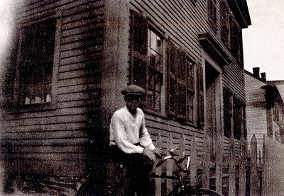 A man poses on a bicycle in the historic "Acre" neighborhood