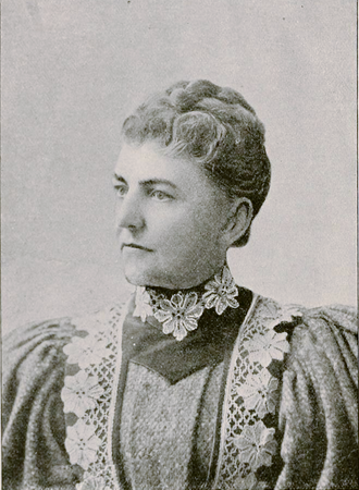 Sepia toned photo of a stern looking woman posing formally in 19th century clothing