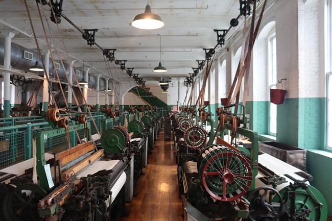 photo looking down an isle with green machines on either side