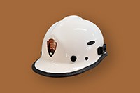 A white hard hat with an National Park Service arrowhead logo
