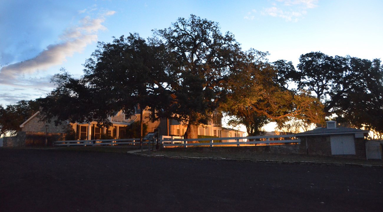 A golden glow lights up the Texas White House in early morning.