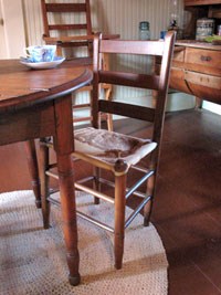The Birthplace's original rawhide chair.  Mrs. Johnson's Roycrafter high chair is in the background.