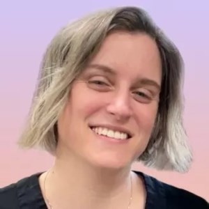 headshot of person smiling at camera with short blonde hair