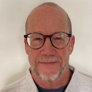 headshot of man looking at camera