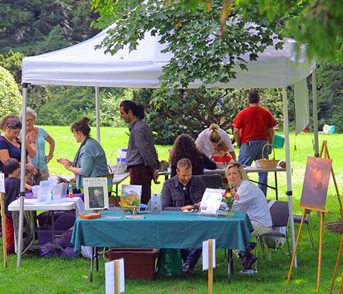 Community Day special event on the Mansion lawn artists and visitors mingle under white awning