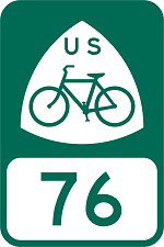 A green road sign for USBR 76