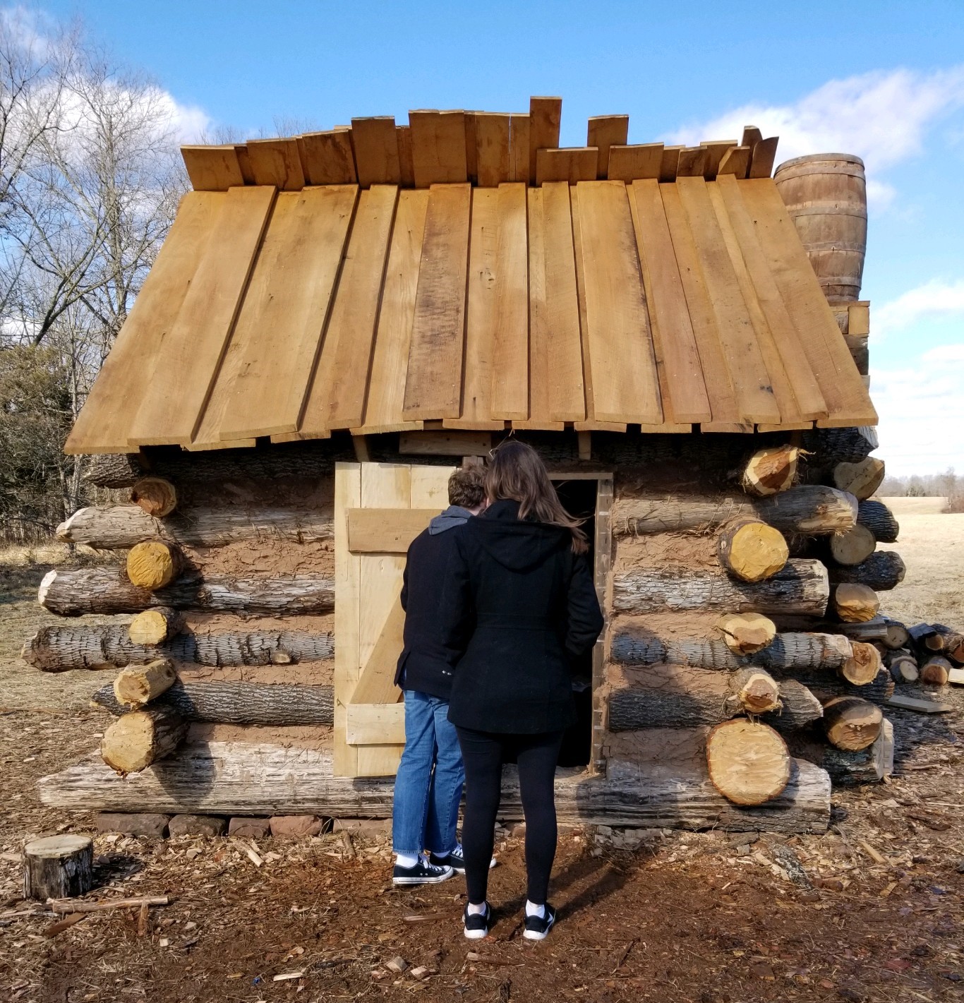 Two visitors entering the winter hut