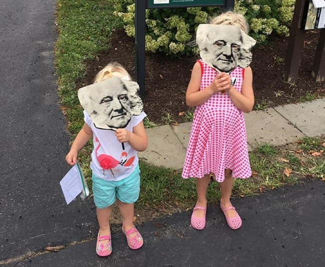 Two children with brightly colored Martin Van Buren masks