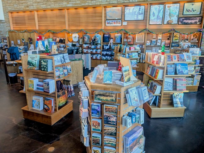 Slatted Wood displays and wall shelves hold books, postcards, bags, T-shirts and other gift product