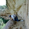 Archeologist documents hand and toe holds that lead to an upper alcove in the Double House cliff dwelling.