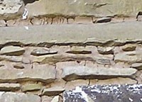 Example of chinking in stone and mortar wall