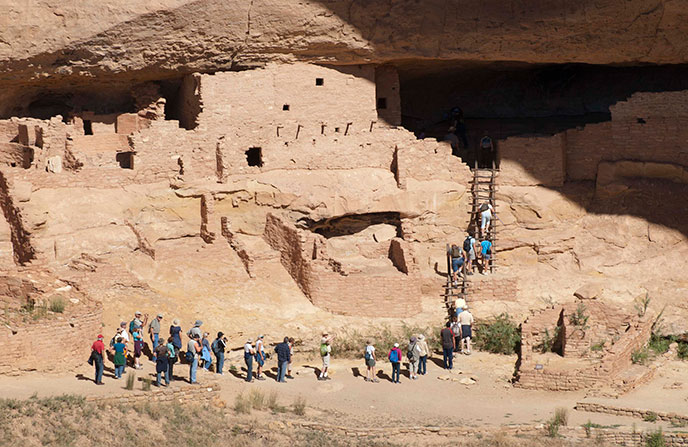 View of visitors on a tour of Long House