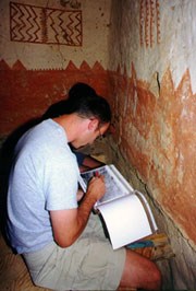 A student documents plaster in Cliff Palace.