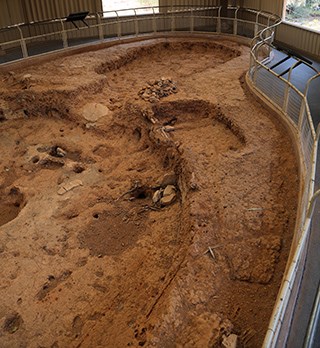 Open archeological showing outlines of the location of an underground pithouse