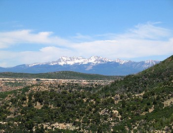 View of high, snowcapped mountains in the distant horizon.