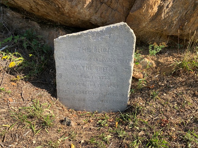 A Stone Monument 3 feet tall engraved with information about the battle at the Bluff