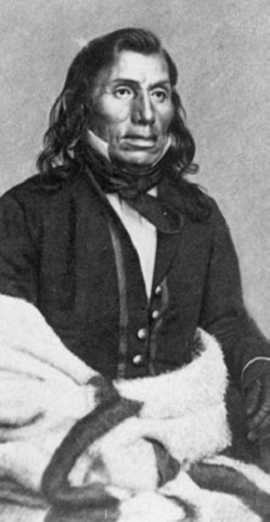 Little Crow, a Dakota, in a uniform and wrapped in a blanket.