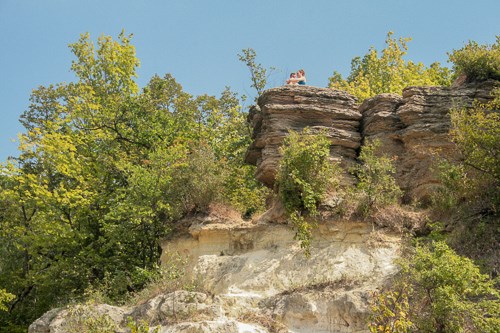People standing on a bluff top.