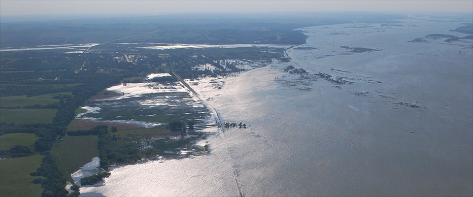 View looking West of a flooded Nebraska Highway 12 with the town of Niobrara in the distance.