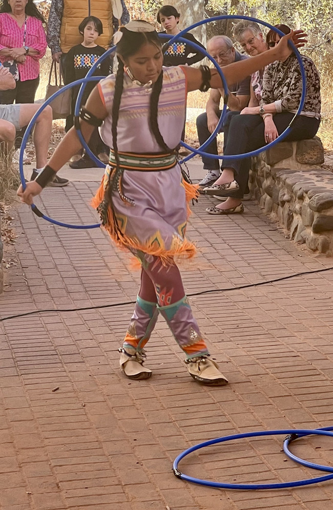 An indigenous hoop dancer in cultural regalia