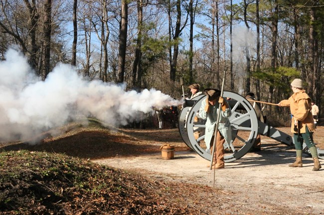 Soldiers firing cannon