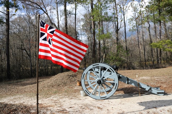 A Patriot Flag Flies in front of a Cannon at the site of the Battle of Moores Creek Bridge