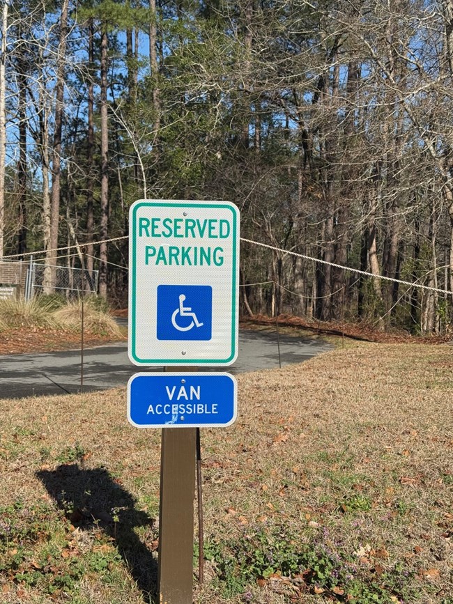 A sign indicating reserved parking for people with disabilities, including van accessible parking.