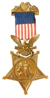 A five-point gold star with an eagle at the top, suspended from a red, white, and blue ribbon.