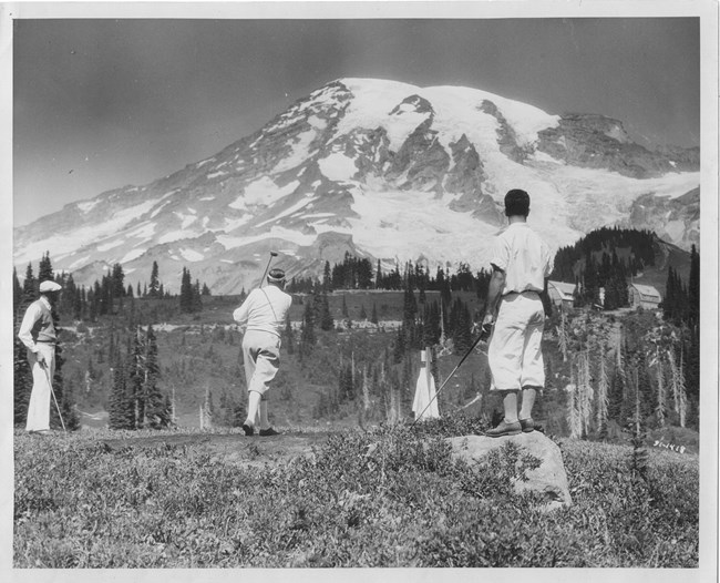 Golfers tee off at Paradise with Mount Rainier in the background.