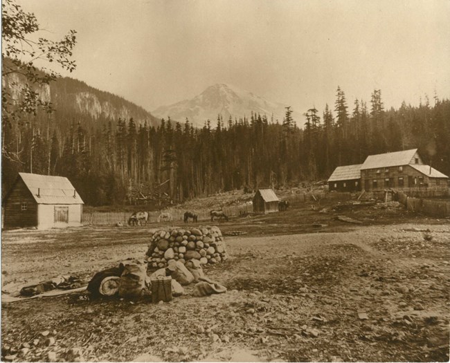 Rustic building in meadow with Mount Rainier rising in the background