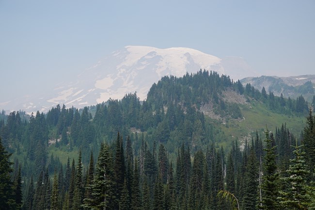 Hazy conditions impair the visibility of Mount Rainier.