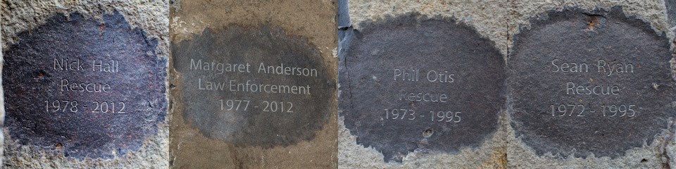 Four images of four names and dates inscribed into rock.