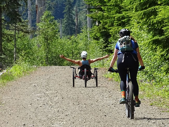 Handcyclist and Mountain Biker on the gravel Westside Road
