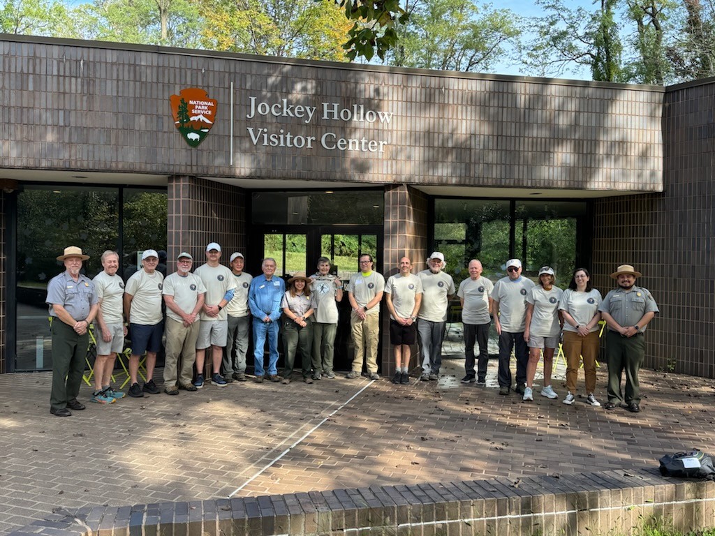 Jockey Hollow Trail Brigade volunteers stand with park staff in front of the Jockey Hollow Visitor Center.