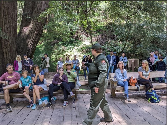 A ranger delivers a program to a group of visitors