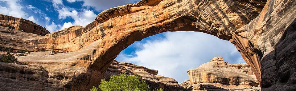 A broad, stone bridge with clouds overhead.