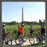 Visitors biking in front of Washington Monument