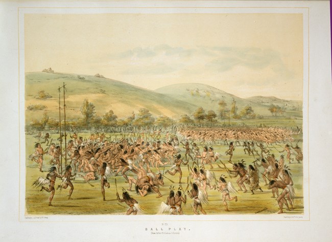 A painting depicting 2 groups of darker skinned men with shoulder length black hair, wearing loin clothes and holding sticks with small oblong nets on the end. The groups all running toward goal posts nearest to them.