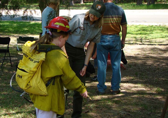 A Junior Ranger wears the fire gear during a special program.