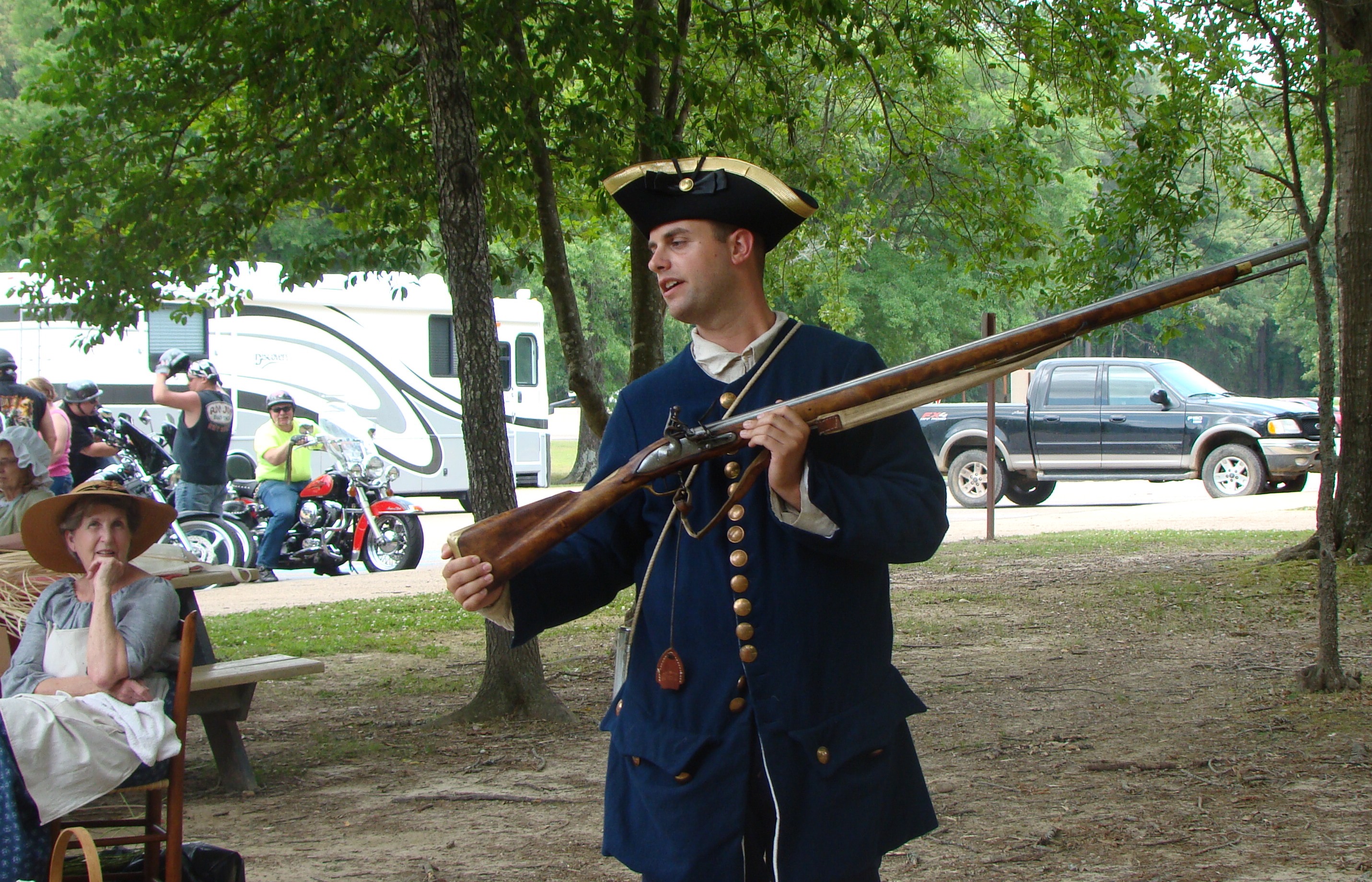 Brian Mast, living historian, talks to a group of visitors at the Natchez Trace Parkway Visitor Center about the weapons used by the French Marines during the Battle of Ackia. NPS Photo.