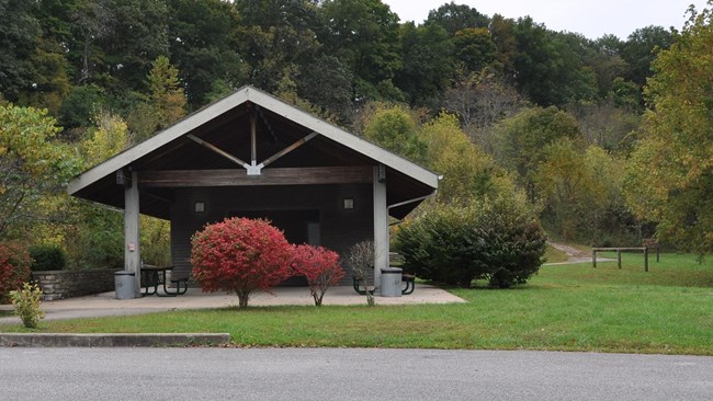 A large picnic pavilion with a trail off to the right.