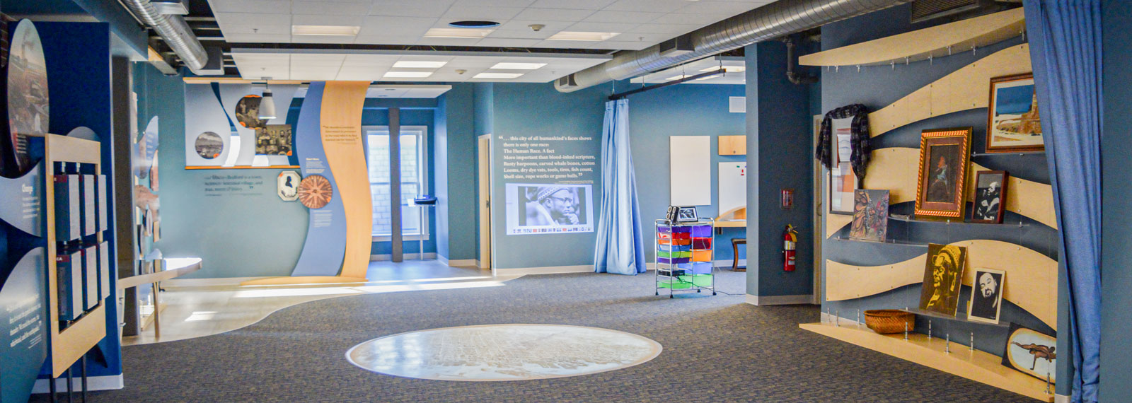An interactive exhibition space at New Bedford Whaling National Historical Park’s Visitor Center features historical displays, artifacts, and hands-on activities.