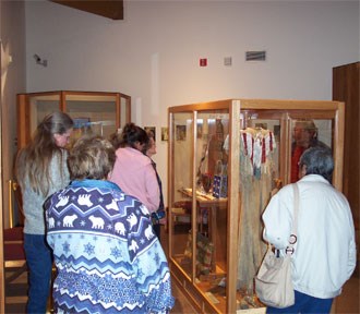 A group of visitors looking at museum exhibits.