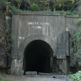 A tall stone and cement tunnel with Great Bend Tunnel written on it