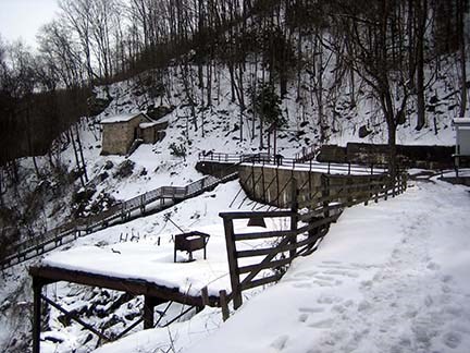 concrete platform sticking out over steep hillside with snow